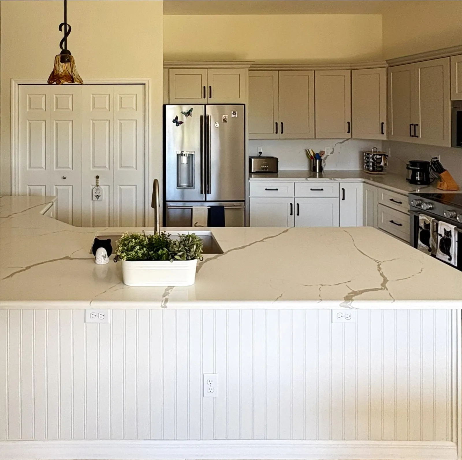 Kitchen remodel with quartz island, beadboard panel and white cabinets in Ocala, FL